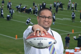 Ashwin Rao ’99 holding a football while wearing his Super Bowl ring.